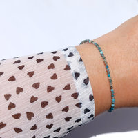Thin agate bracelet in shades of light blue and gray with tiny silver-plated beads, stainless steel lobster claw clasp