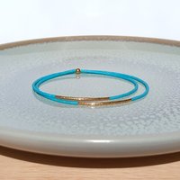 Thin miyuki stretch wrapped bracelet, summer jewelry of tiny blue-green teal beads and gold-plated beads, minimalist, comfortable and light