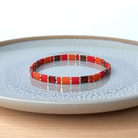 Elegant miyuki tila beads bracelet strung on two strands of transparent stretch cord with dark red, picasso red, terracotta orange and gold-plated tila beads.  Handmade with care and attention to detail and made to order at your size  Available sizes (length): 15cm (5.9in), 16cm (6.3in), 17cm (6.7in), 18cm (7.1in) - make your choice from the drop-down menu when you order.