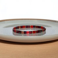 Elegant miyuki tila beads bracelet strung on transparent stretch cord - two strands with Japanese tila beads in transparent picasso ruby red, dark red and gold-plated tila beads  Handmade with care and attention to detail and made to order at your size  Available sizes (length): 15cm (5.9in), 16cm (6.3in), 17cm (6.7in), 18cm (7.1in) 