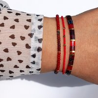 Miyuki tila stretch bracelet, transparent ruby red and gold-plated tila beads