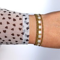 Elegant Japanese miyuki glass beads bracelet strung on transparent stretch cord - comfortable enough to wear every day yet elegant in a subtle way.  Two strands with white tila beads and the tiniest size rocailles in golden olive green and gold color  Wear alone for an understated minimalist look or add to your bracelet stack for a boho look  All our jewellery is handmade with care and attention to detail in Amsterdam, The Netherlands. This bracelet is made to order at your size.