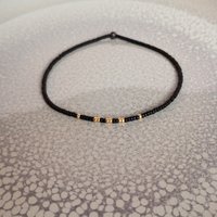 Thin miyuki stretch bracelets with matte black, gold, silver and bronze color tiny beads, four designs in minimalist style