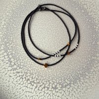Thin miyuki stretch bracelets with matte black, pearl-white and bronze color tiny beads, three designs in minimalist style