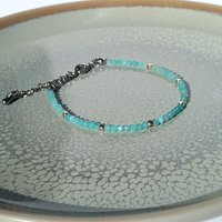 Thin gem bracelet with tiny faceted light blue-green jade and silver-plated cube-shaped beads, stainless steel lobster claw clasp
