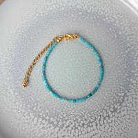 Thin gem bracelet with tiny faceted light blue-green jade and gold-plated tiny beads, stainless steel lobster claw clasp