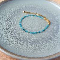 Thin gem bracelet with tiny faceted light blue-green jade and gold-plated tiny beads, stainless steel lobster claw clasp