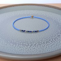 Thin miyuki stretch bracelets with blue sodalite, matte tiny glass beads and gold-plated beads, three designs in minimalist style