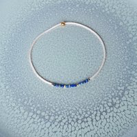 Thin miyuki stretch bracelets with blue sodalite, matte tiny glass beads and gold-plated beads, three designs in minimalist style