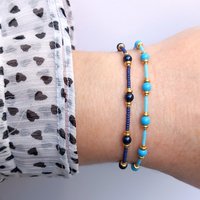 Thin miyuki stretch bracelets with blue crystal pearls, matte tiny glass beads and gold color beads, two designs in minimalist style