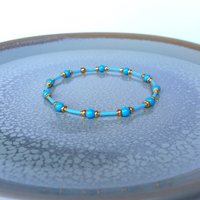 Thin miyuki stretch bracelets with blue crystal pearls, matte tiny glass beads and gold color beads, two designs in minimalist style
