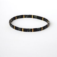 Elegant miyuki tila beads bracelet strung on transparent stretch cord with black and gold-plated tila beads