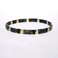 Elegant miyuki tila beads bracelet strung on transparent stretch cord with black and gold-plated tila beads