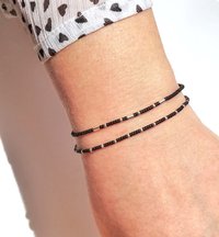 A set of two thin miyuki stretch bracelets made with tiny rocaille beads in black and silver color, minimalist style, light, seed beads
