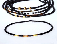 Dainty miyuki beads bracelet set strung on black stretch cord that can be stacked together or worn separately for a minimalist look.  Four designs currently available in matte black, gold, silver and bronze color