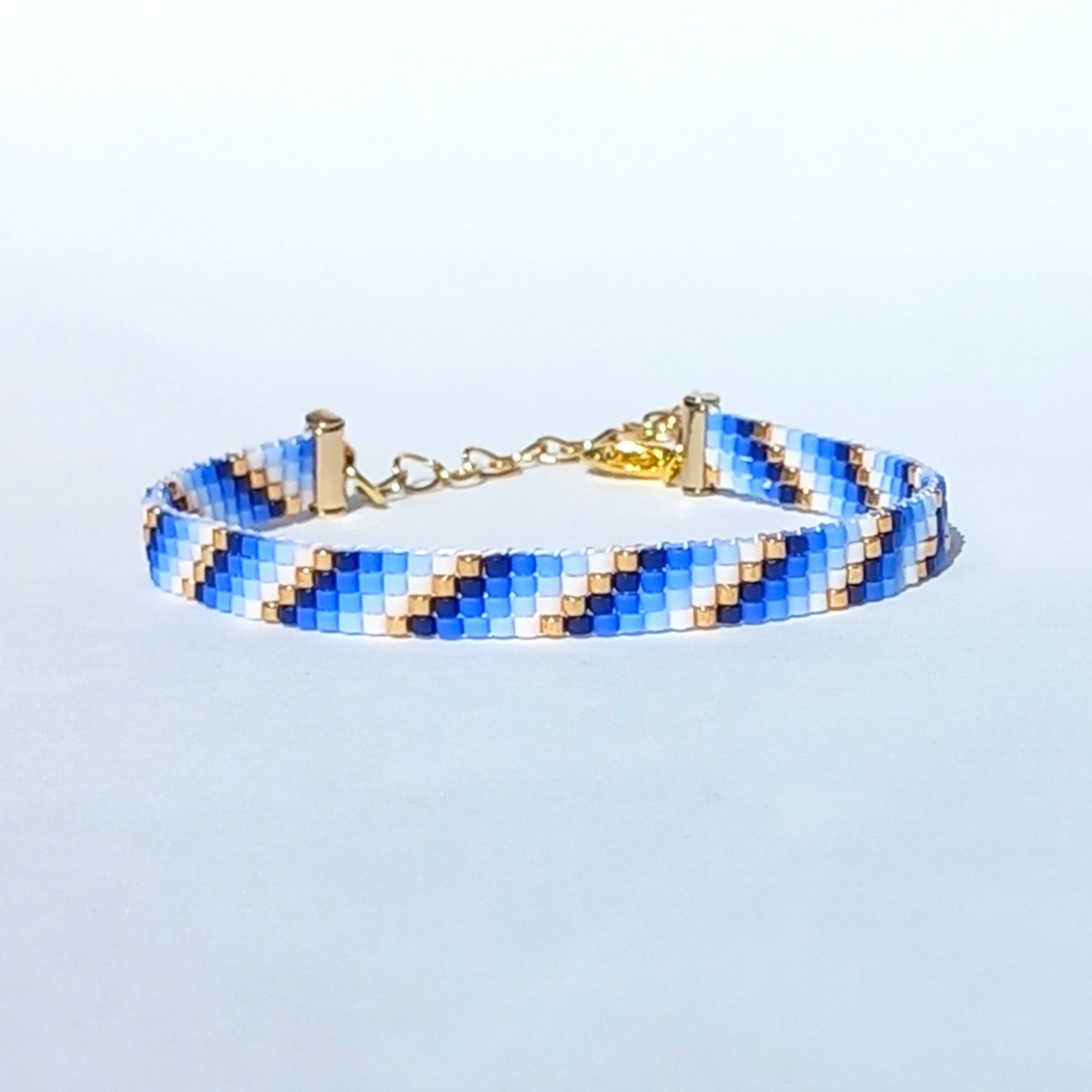 Glass beaded bracelet, summer jewelry of tiny blue, white and gold-color beads, adjustable loom bracelet with lobster claw clasp