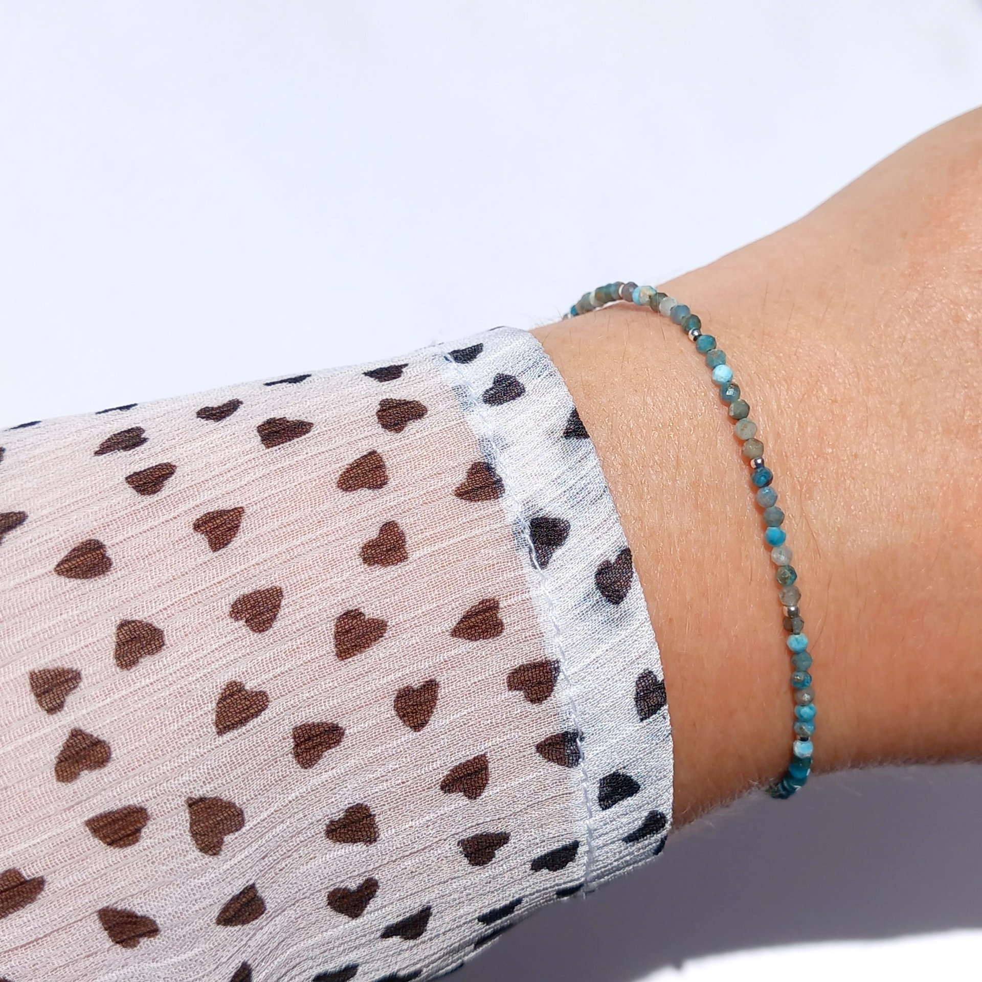 Thin agate bracelet in shades of light blue and gray with tiny silver-plated beads, stainless steel lobster claw clasp