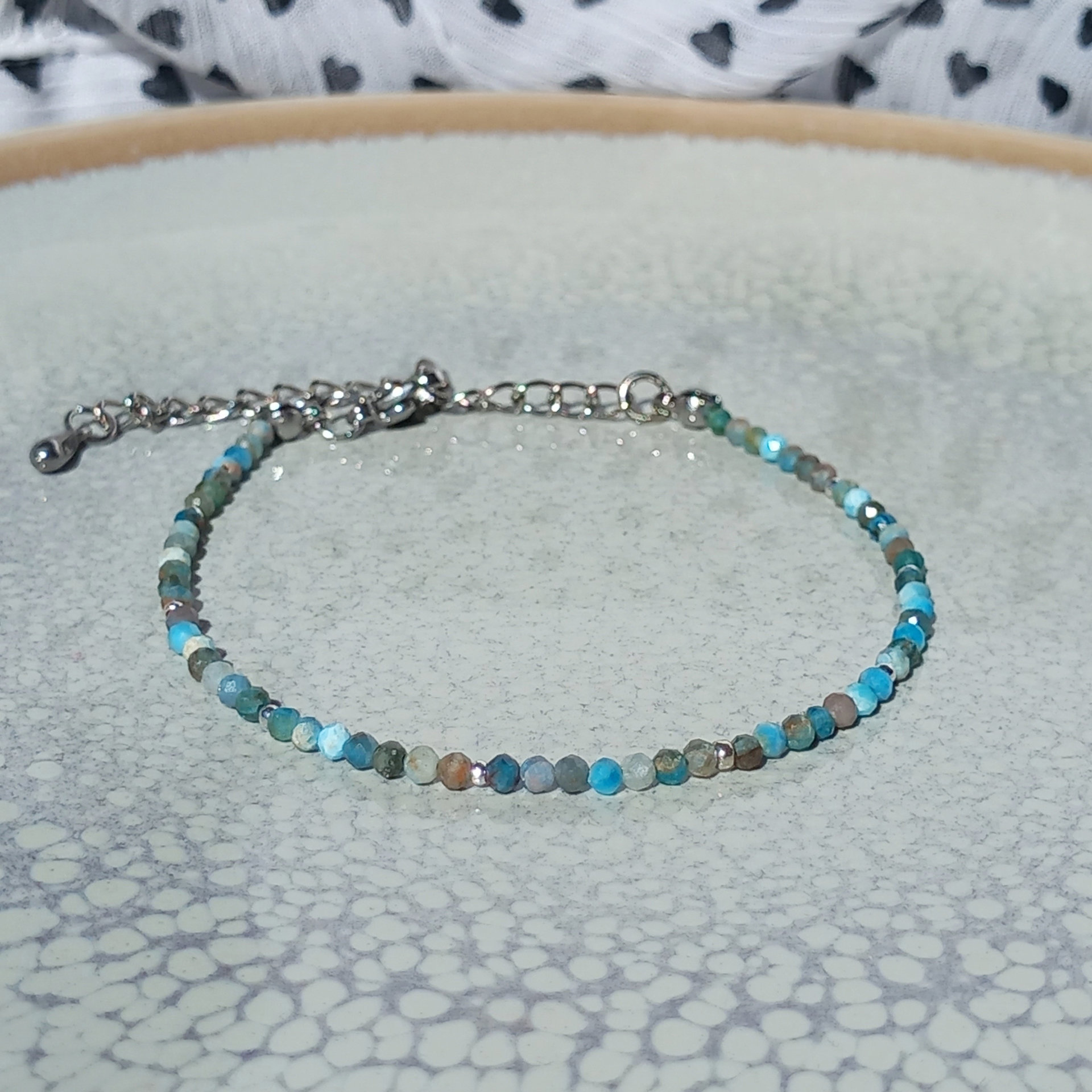 Thin agate bracelet in shades of light blue and gray with tiny silver-plated beads, stainless steel lobster claw clasp
