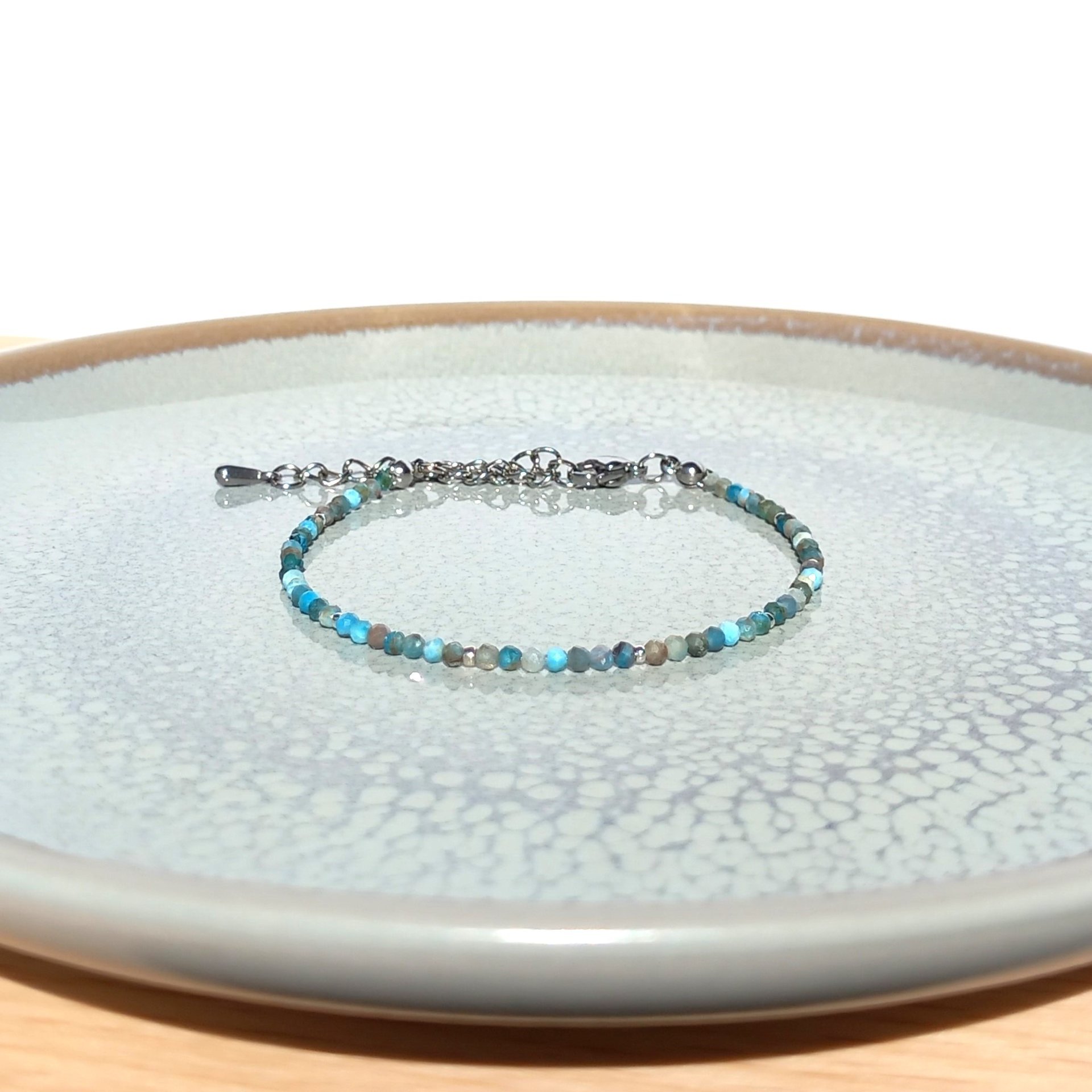 Thin agate bracelet in shades of light blue and gray with tiny silver-plated beads, stainless steel lobster claw clasp