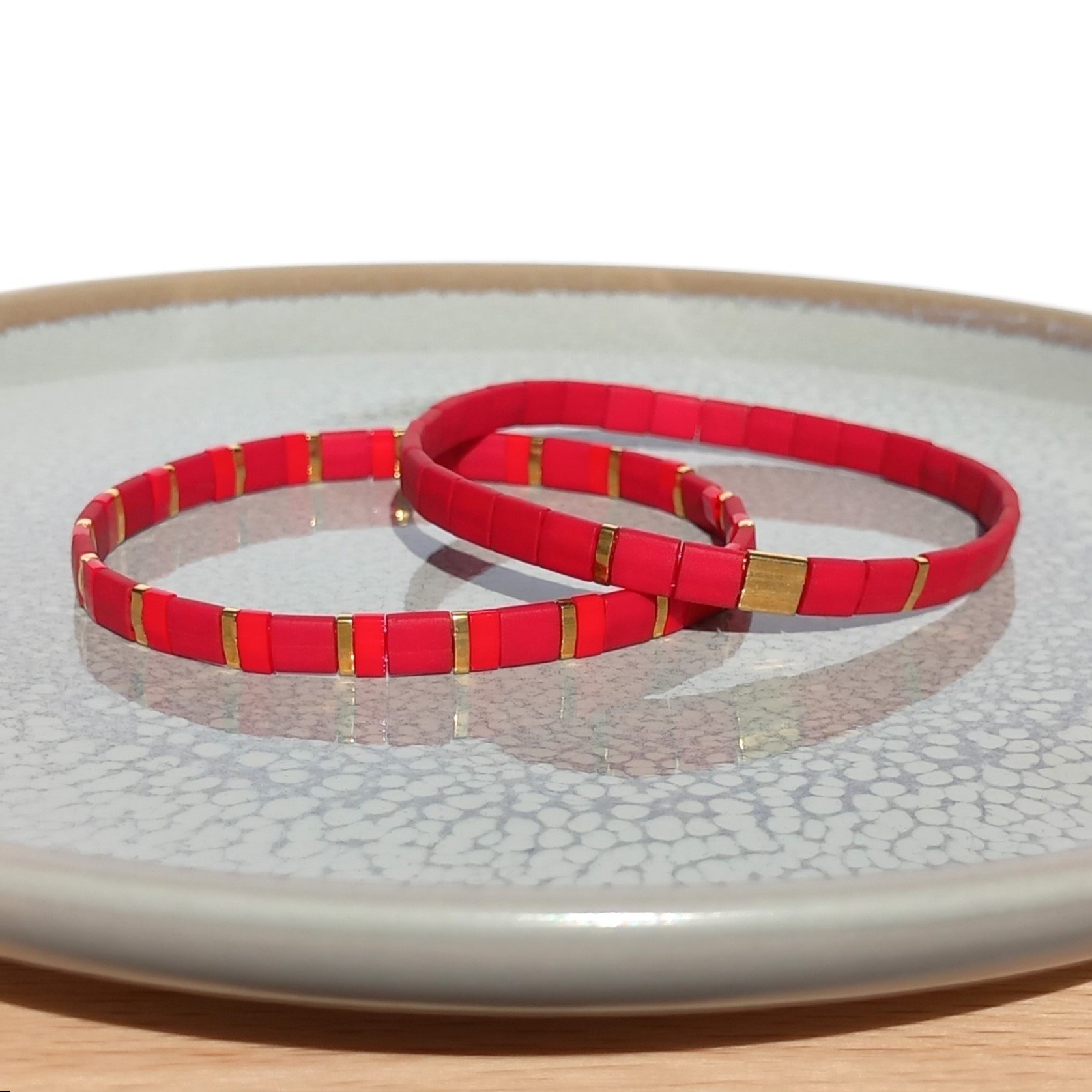 Elegant miyuki tila bracelet set strung on transparent stretch cord  Two bracelets in matching colours; each bracelet is on two strands of stretch cord with shades of matte red and gold colour tila beads with bright red accents  Handmade with care and attention to detail and made to order at your size  Available sizes: 15cm (5.9in), 16cm (6.3in), 17cm (6.7in), 18cm (7.1in)