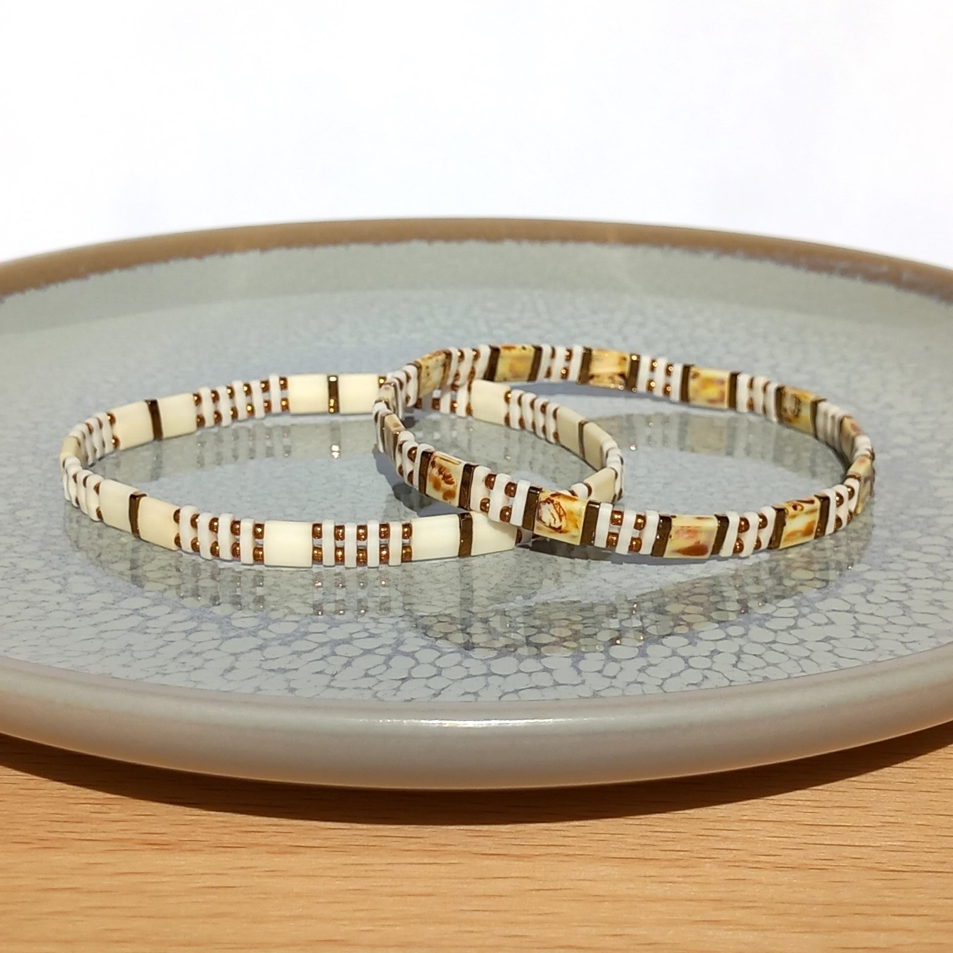 Elegant miyuki tila and rocaille bracelet set strung on transparent stretch cord  Two bracelets in matching colours; each bracelet is on two strands of stretch cord with light caramel and cream tila beads and tiny bronze colour rocaille beads  Handmade with care and attention to detail and made to order at your size  Available sizes: 15cm (5.9in), 16cm (6.3in), 17cm (6.7in), 18cm (7.1in)