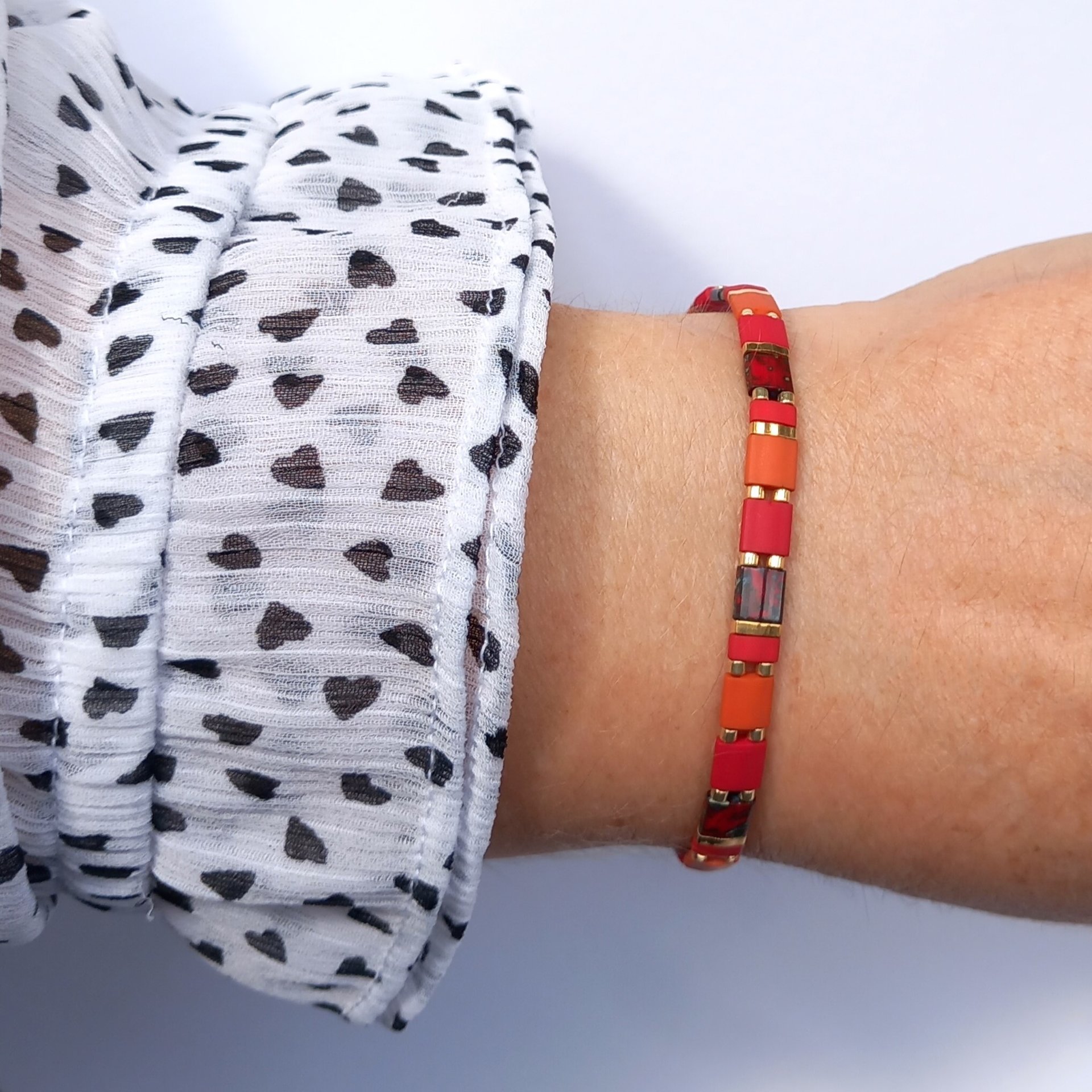 Elegant miyuki tila beads bracelet strung on two strands of transparent stretch cord with dark red, picasso red, terracotta orange and gold-plated tila beads.  Handmade with care and attention to detail and made to order at your size  Available sizes (length): 15cm (5.9in), 16cm (6.3in), 17cm (6.7in), 18cm (7.1in) - make your choice from the drop-down menu when you order.