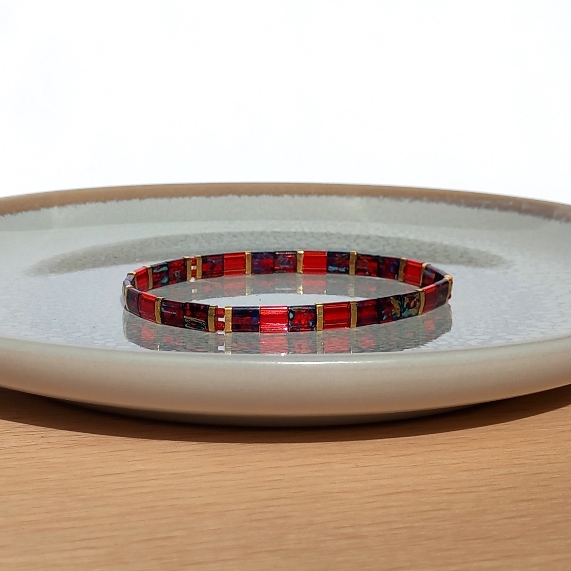 Elegant miyuki tila beads bracelet strung on transparent stretch cord - two strands with Japanese tila beads in transparent picasso ruby red, dark red and gold-plated tila beads  Handmade with care and attention to detail and made to order at your size  Available sizes (length): 15cm (5.9in), 16cm (6.3in), 17cm (6.7in), 18cm (7.1in) 