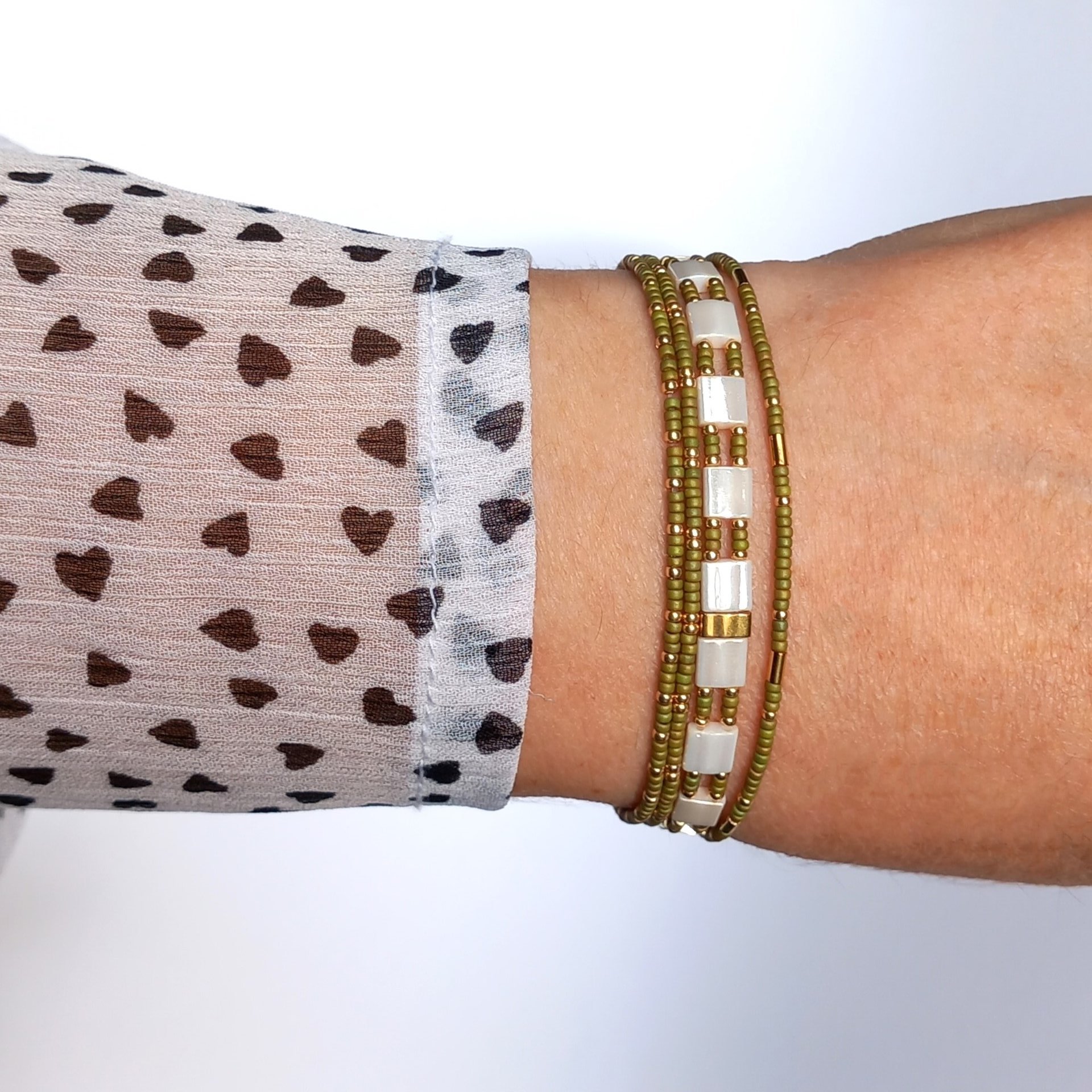 Elegant Japanese miyuki glass beads bracelet strung on transparent stretch cord - comfortable enough to wear every day yet elegant in a subtle way.  Two strands with white tila beads and the tiniest size rocailles in golden olive green and gold color  Wear alone for an understated minimalist look or add to your bracelet stack for a boho look  All our jewellery is handmade with care and attention to detail in Amsterdam, The Netherlands. This bracelet is made to order at your size.