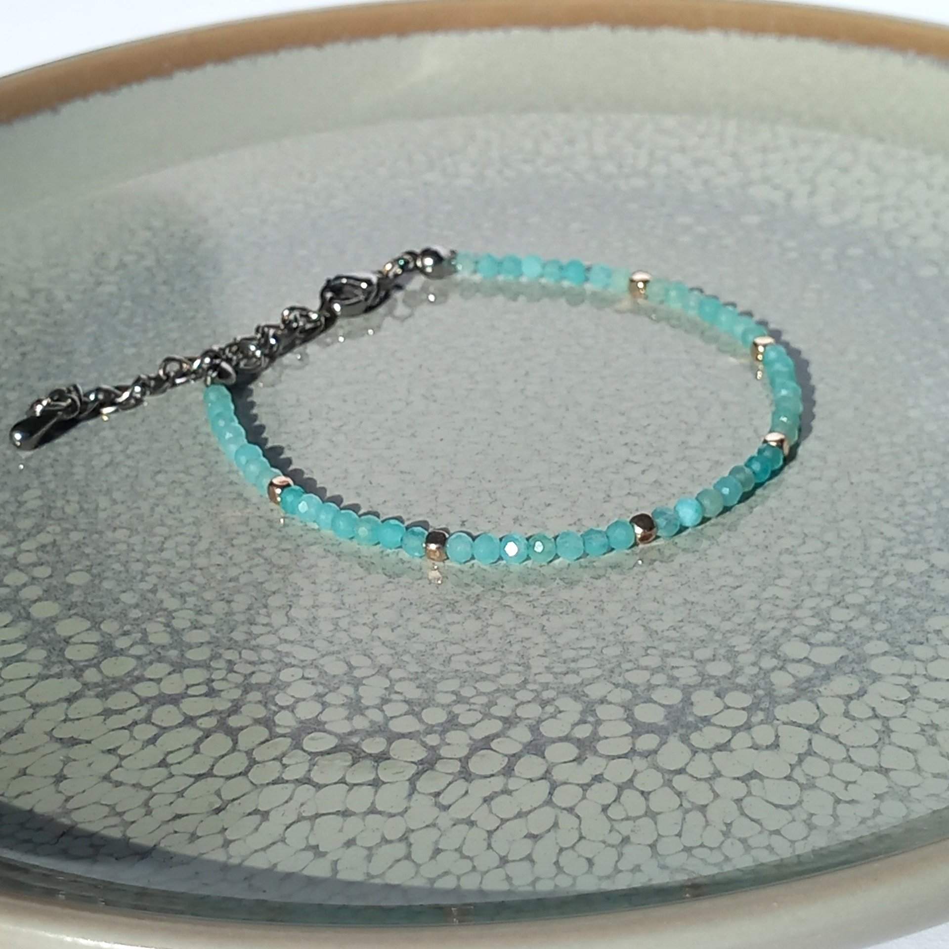Thin gem bracelet with tiny faceted light blue-green jade and silver-plated cube-shaped beads, stainless steel lobster claw clasp