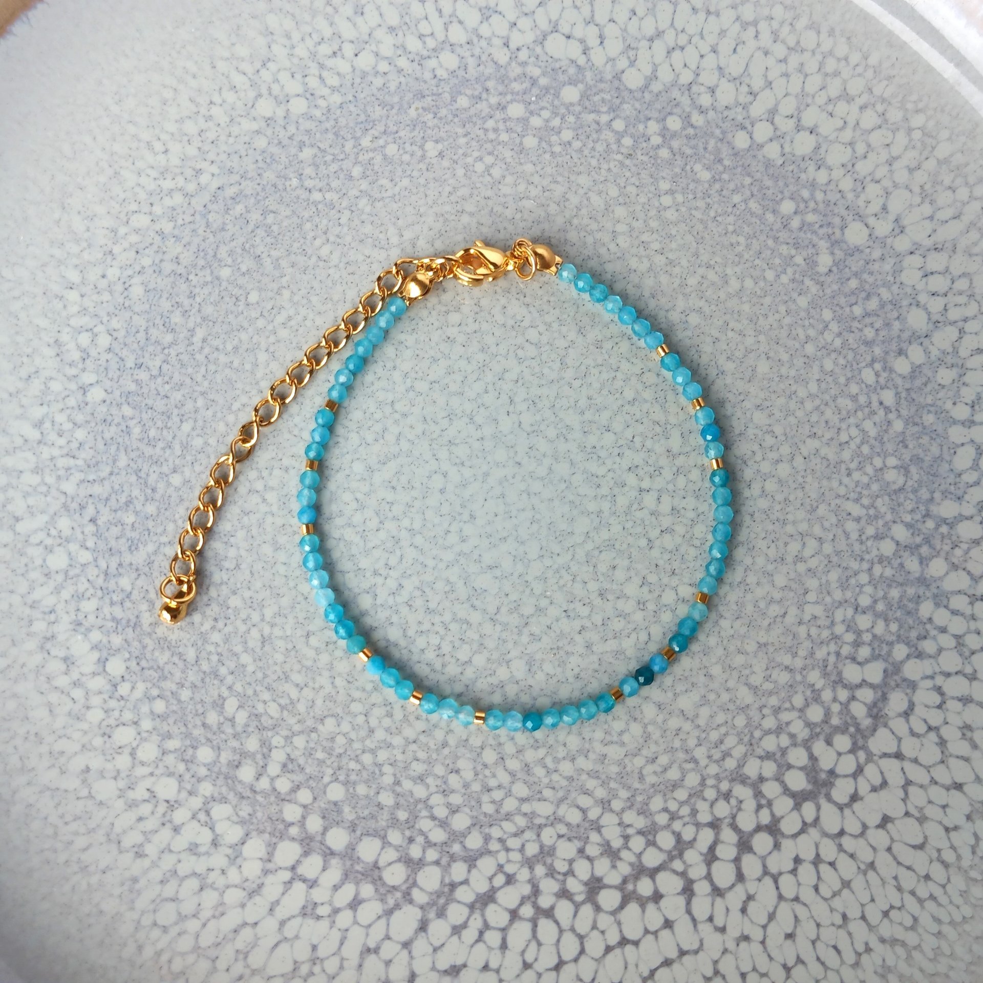 Thin gem bracelet with tiny faceted light blue-green jade and gold-plated tiny beads, stainless steel lobster claw clasp