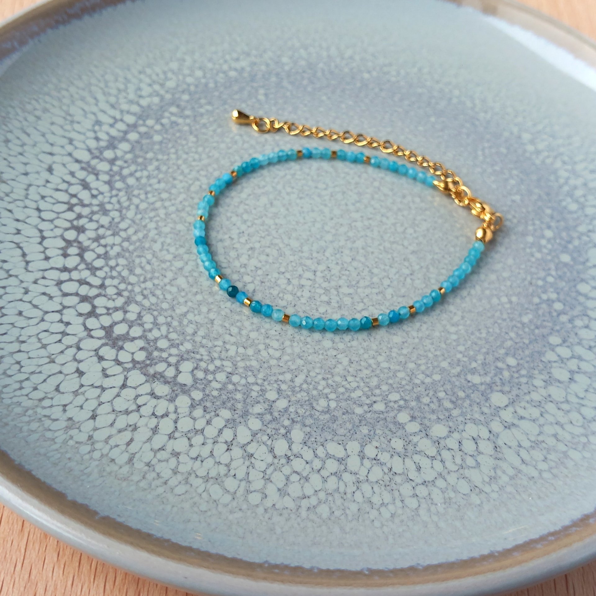 Thin gem bracelet with tiny faceted light blue-green jade and gold-plated tiny beads, stainless steel lobster claw clasp
