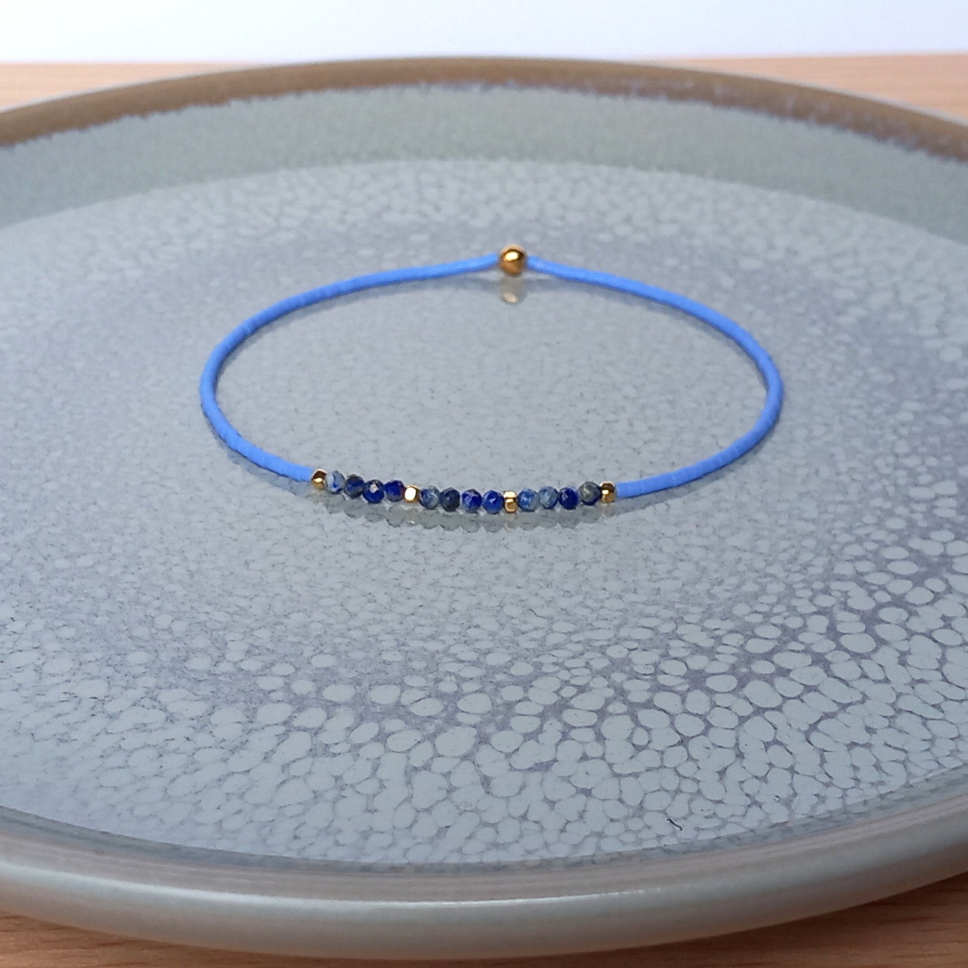 Thin miyuki stretch bracelets with blue sodalite, matte tiny glass beads and gold-plated beads, three designs in minimalist style