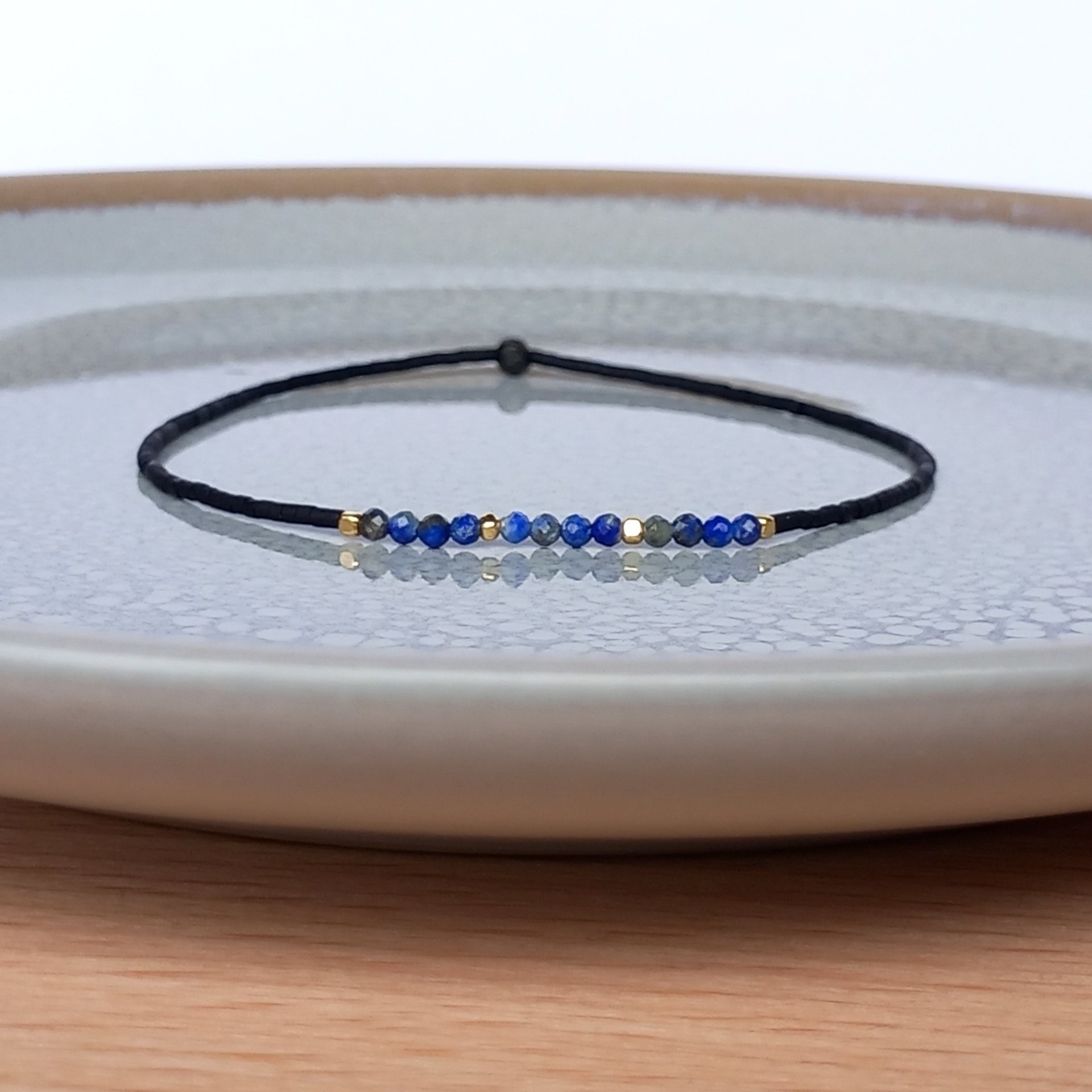 Thin miyuki stretch bracelets with blue sodalite, matte tiny glass beads and gold-plated beads, three designs in minimalist style