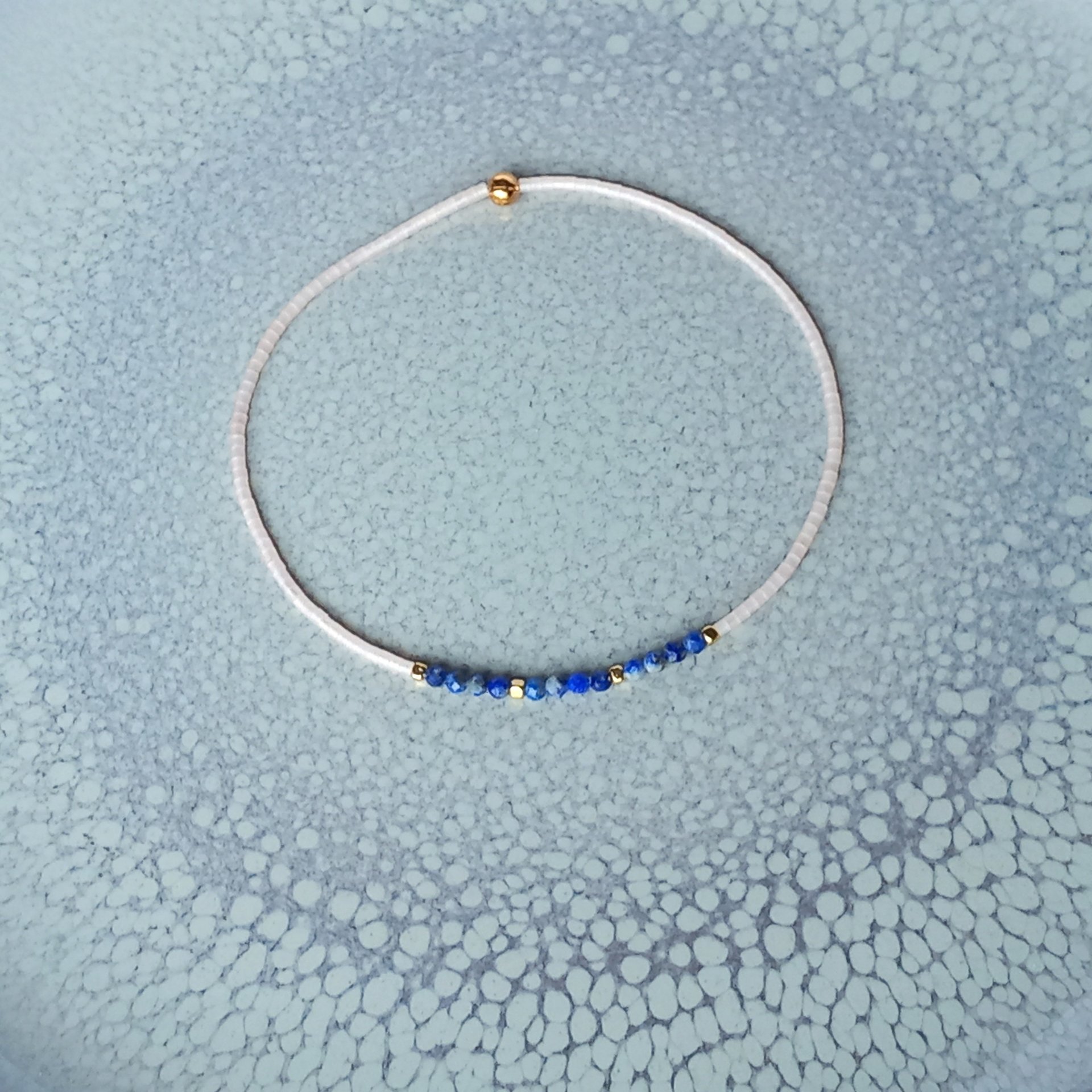 Thin miyuki stretch bracelets with blue sodalite, matte tiny glass beads and gold-plated beads, three designs in minimalist style