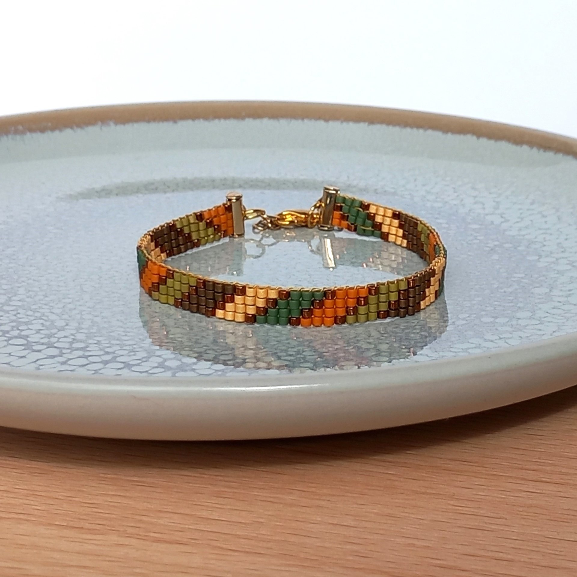 Glass beaded bracelet made with tiny beads in earth tones, stylish adjustable loom bracelet with lobster claw clasp