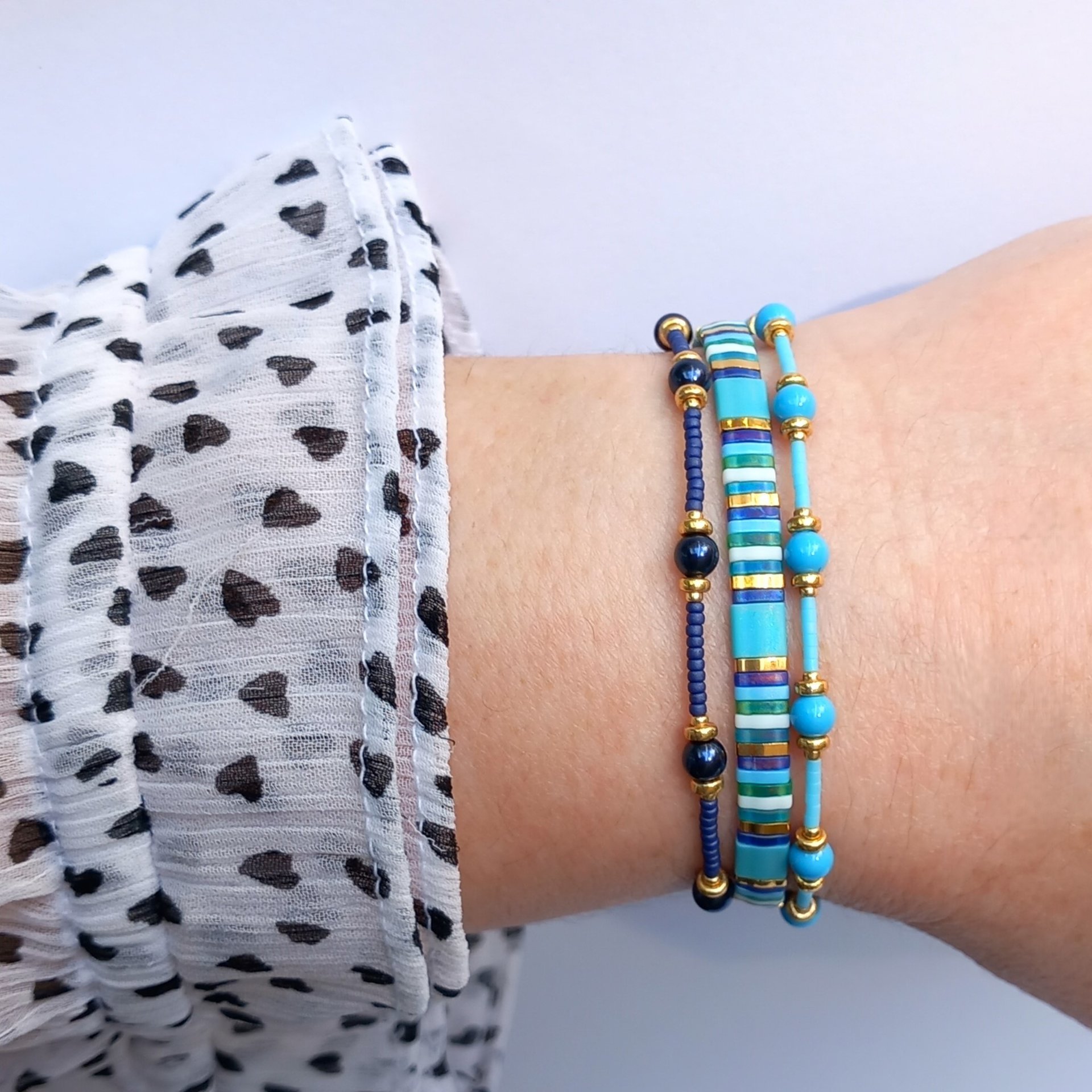 Thin miyuki stretch bracelets with blue crystal pearls, matte tiny glass beads and gold color beads, two designs in minimalist style