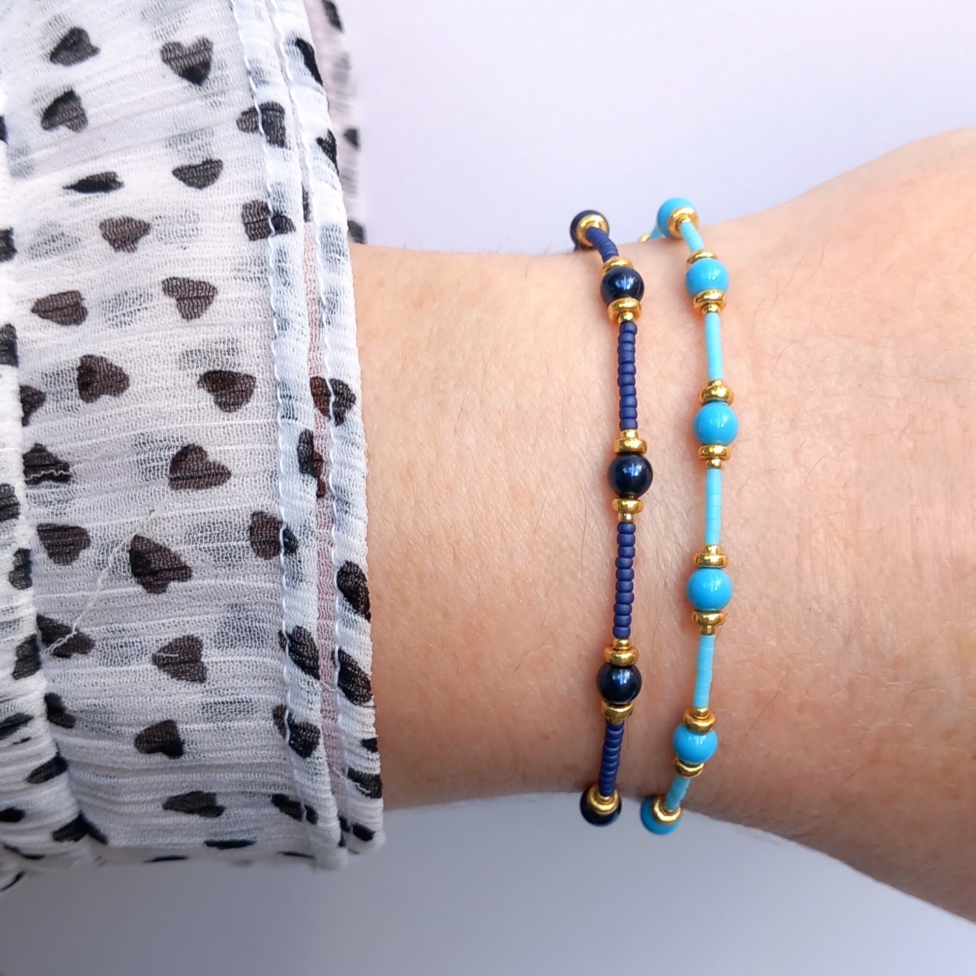 Thin miyuki stretch bracelets with blue crystal pearls, matte tiny glass beads and gold color beads, two designs in minimalist style
