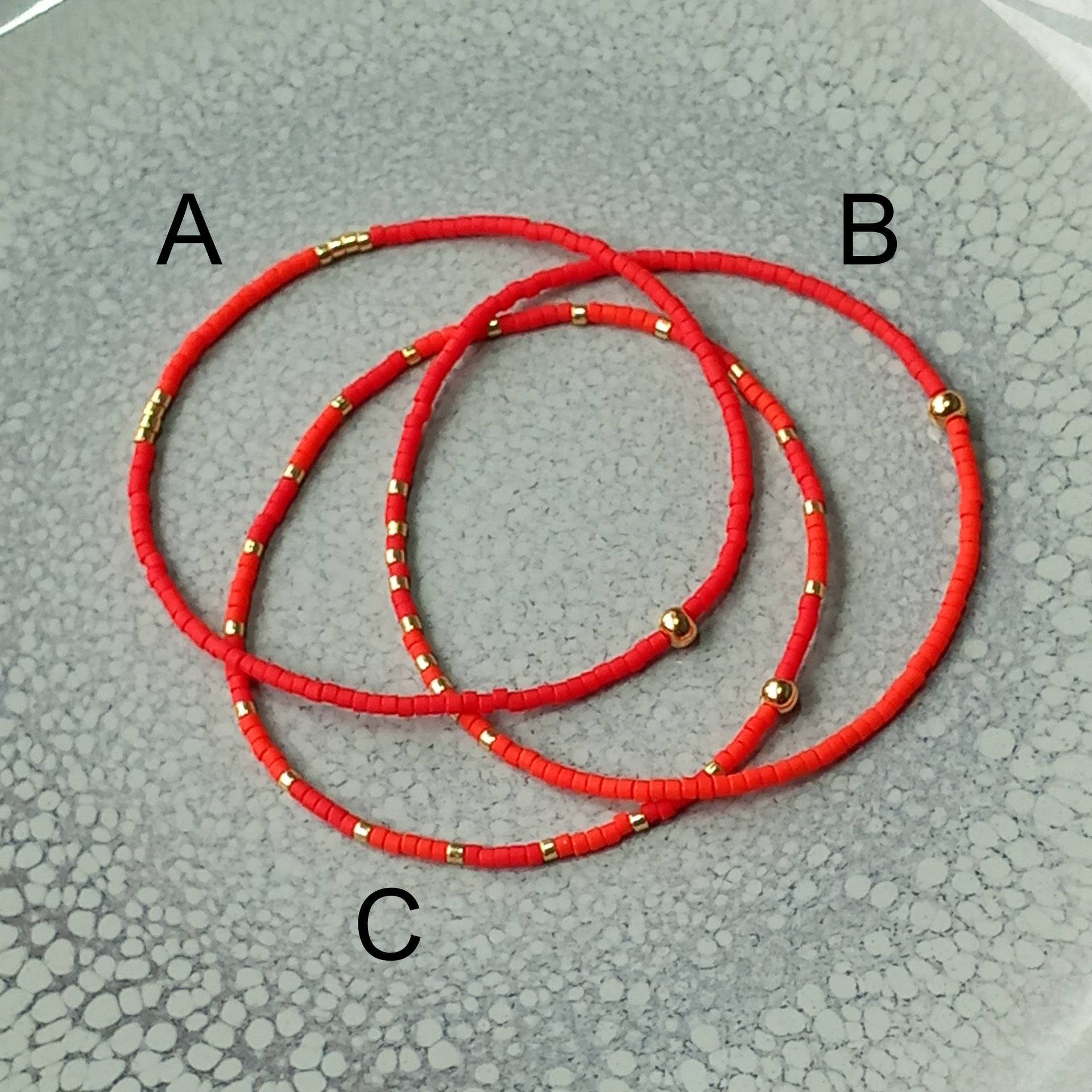 Delicate miyuki stretch bracelet in red with gold color accents, single or a set of bracelets, comfortable and light