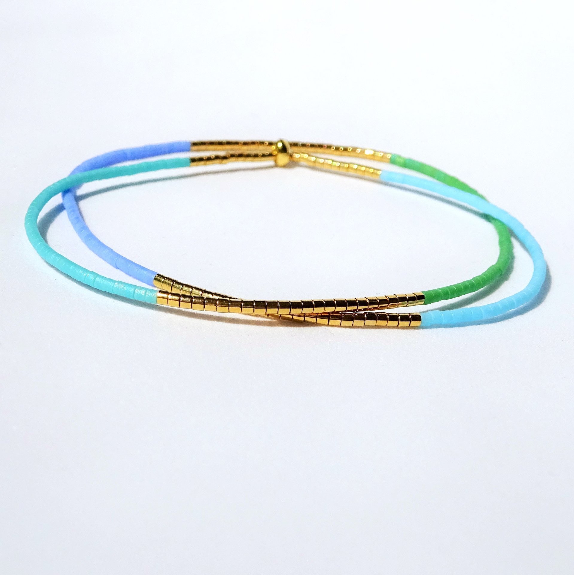 Thin miyuki wrapped stretch bracelet with blue, green and gold-plated tiny beads, minimalist summer jewelry