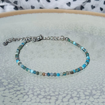 Thin agate bracelet in shades of light blue and gray with tiny silver-plated beads, stainless steel lobster claw clasp
