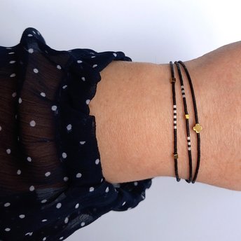 Thin miyuki stretch bracelets with matte black, pearl-white and bronze color tiny beads, three designs in minimalist style
