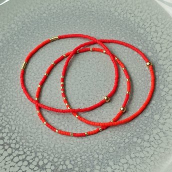 Delicate miyuki stretch bracelet in red with gold color accents, single or a set of bracelets, comfortable and light
