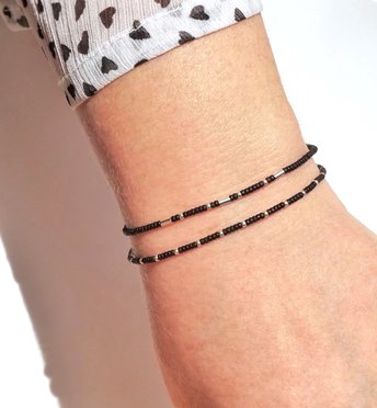A set of two thin miyuki stretch bracelets made with tiny rocaille beads in black and silver color, minimalist style, light, seed beads